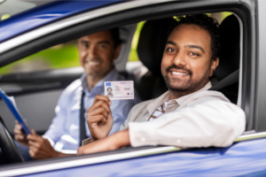 A man is pictured here showing off his new driver's license.