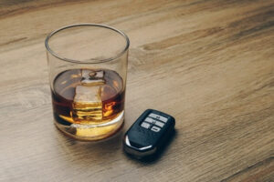 This a photo illustration of a cocktail glass and key fob used to draw attention to risks involved with drunk driving.